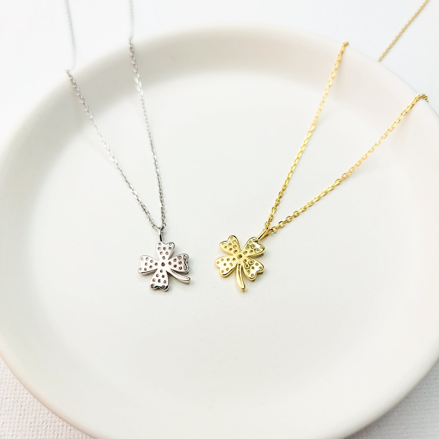 A beautiful design featuring a graceful four-leaf clover handcrafted in Sterling Silver and plated in 14 K Gold, the Lucky Clover and Sparkles Necklace showcases tiny cubic zirconia stones ( pink or white). Recognized as the universal symbol of good luck, this clover pendant necklace can be a wonderful gift for any occasion. Options: Sterling Silver with14 K White Gold Plating and Pink Zirconia Stones Sterling Silver with 14 K Yellow Gold Plating and White Zirconia Stones