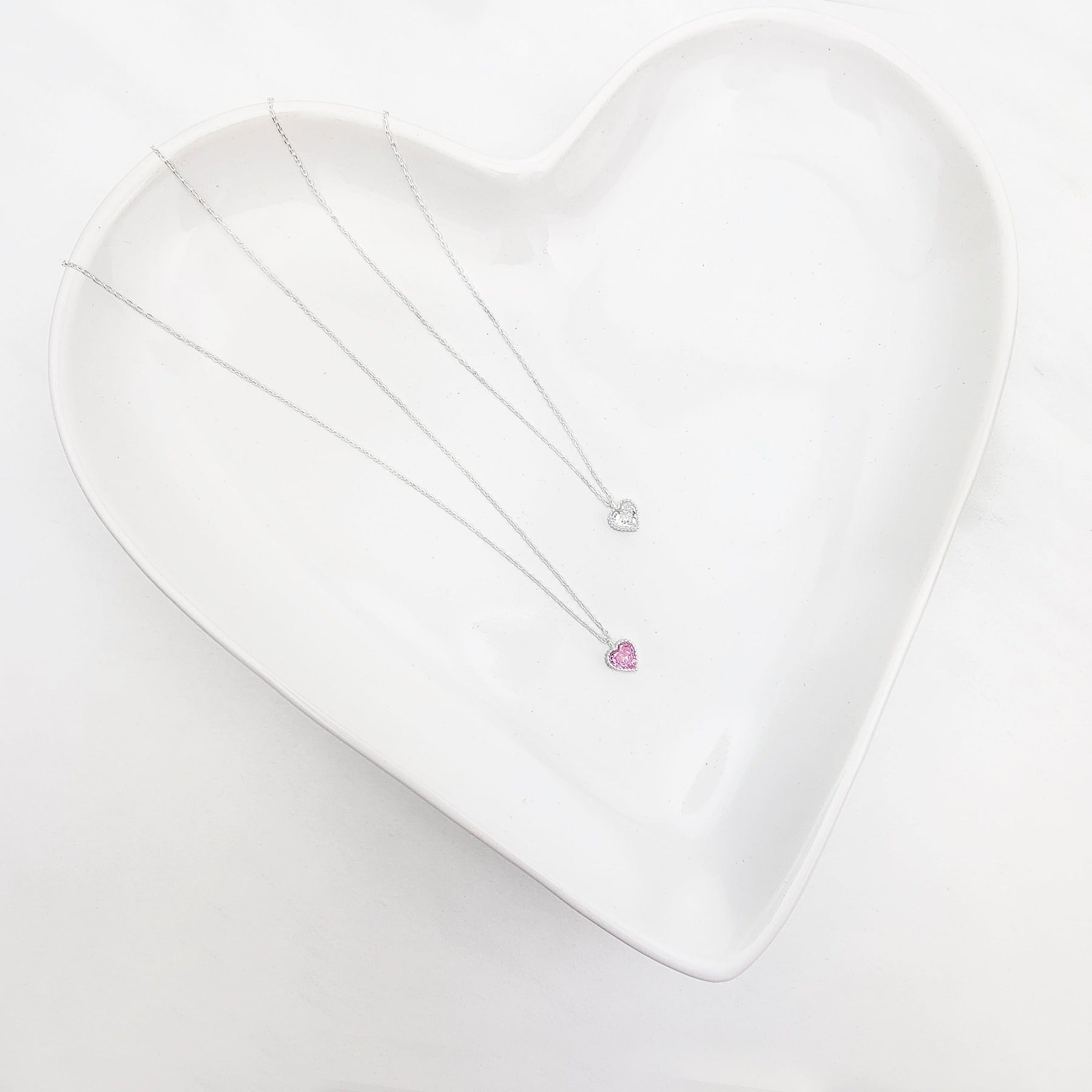Hot Pink, shimmering White or both? This Brilliant Heart necklace crafted in Sterling Silver and embellished with pink or white heart shaped zirconia stones makes a great statement for any outfit. It's gorgeous and can be worn on daily basis or for special occasions. Metal: 925 Sterling Silver Chain Length:16 Inches + 2 inches extension Nickel & Lead free & Hypoallergenic