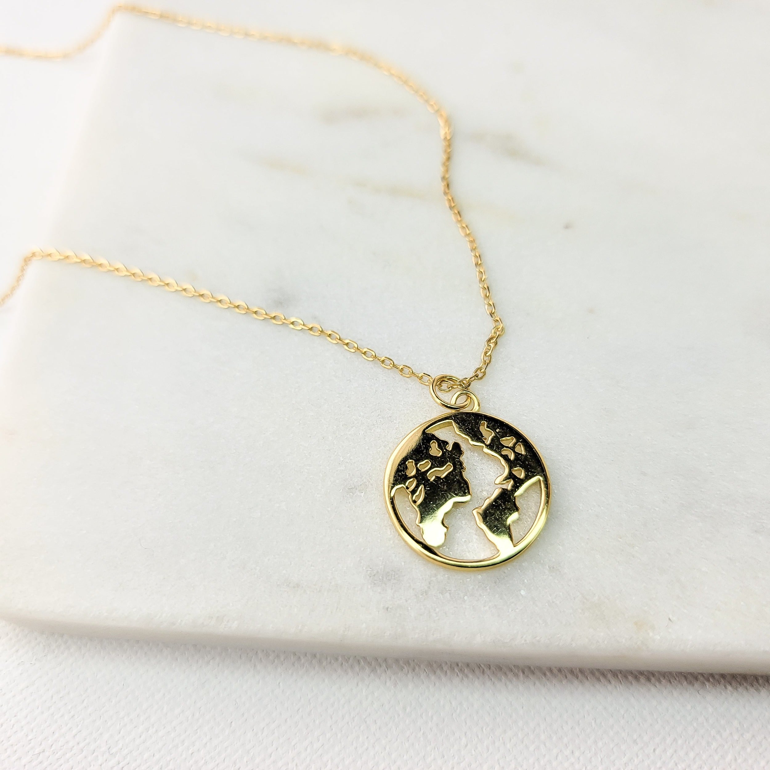 This world map necklace is your dynamic jewelry piece that will be signature to your look. It is elegant, yet casual for everyday wear. This necklace is the simplistic symbol of the traveler at heart and an invitation for conversation. Metal: 925 Sterling Silver with 18 K Gold plating Length :15.5 inches + 2 inches Nickel & Lead-free & Hypoallergenic