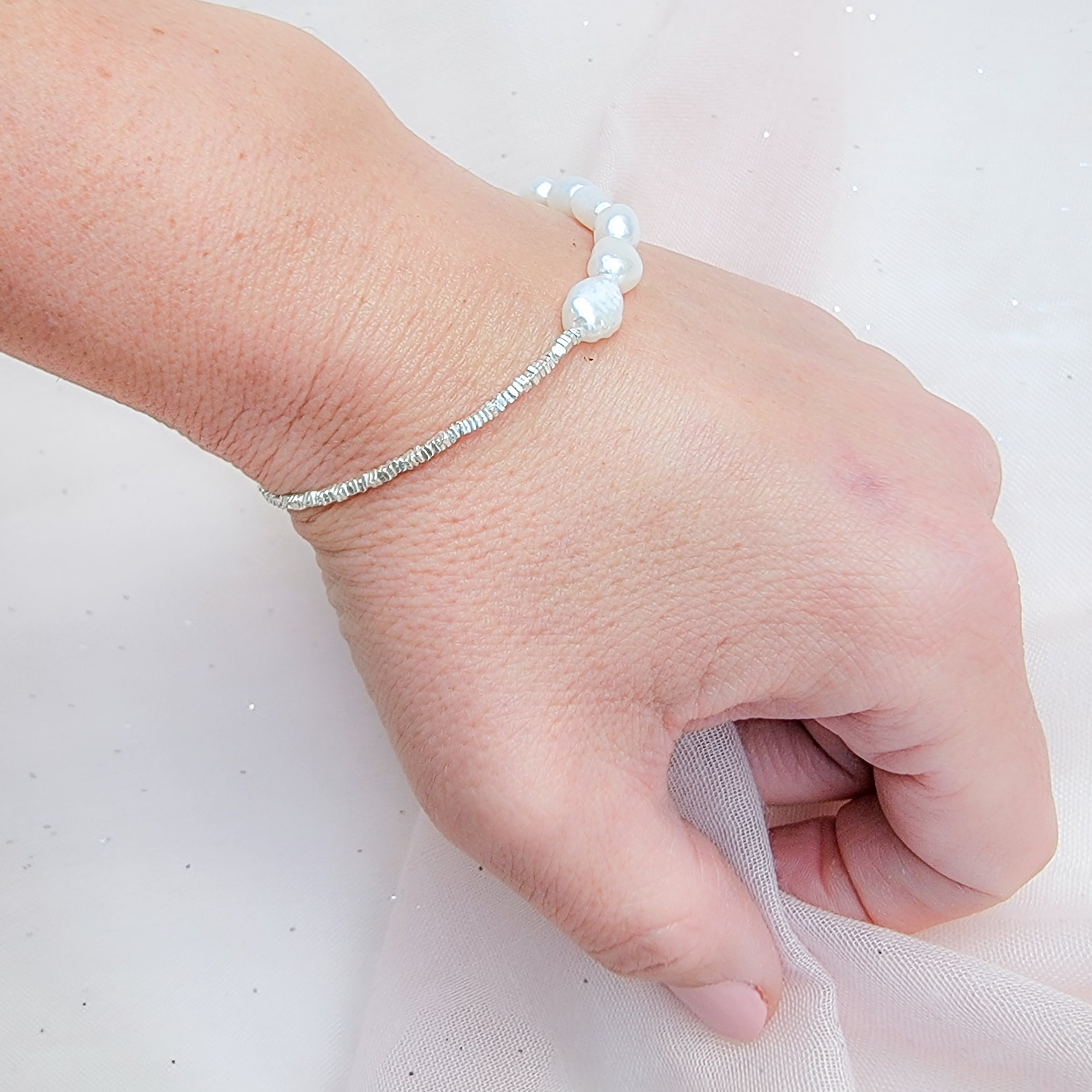 The Pearl-Silver Fusion Bracelet, just like the matching necklace is a stunning blend of romance and style, featuring a unique composition of half baroque pearls and half sterling silver chain. Its design exudes a romantic charm, making it a versatile accessory suitable for various occasions. It can be your elegant bridal necklace, adding a touch of timeless beauty to your wedding attire. 