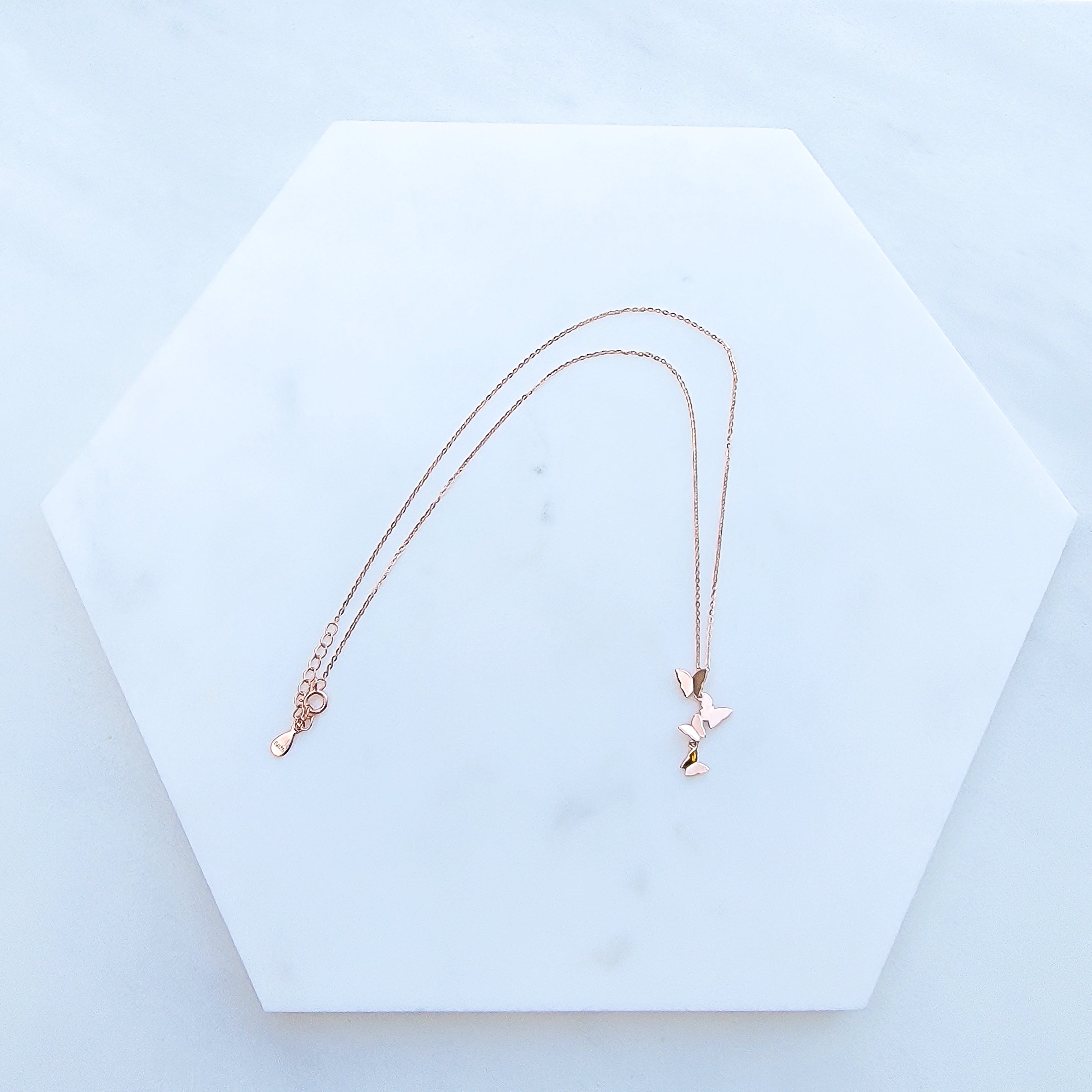 Add elegance and grace to your looks with this charming symbol of new life, letting go of old cycles and finding your true inner expression. Crafted in 925 Sterling Silver and dipped in Rose Gold, this delicate necklace features a group of four graceful butterflies. It’s the perfect gift to yourself or somebody special.  Material: Rose Gold plating over 925 Sterling Silver base Necklace length: 16 inch Pendant Shape: four-leaf clover Nickel & Lead-free & Hypoallergenic