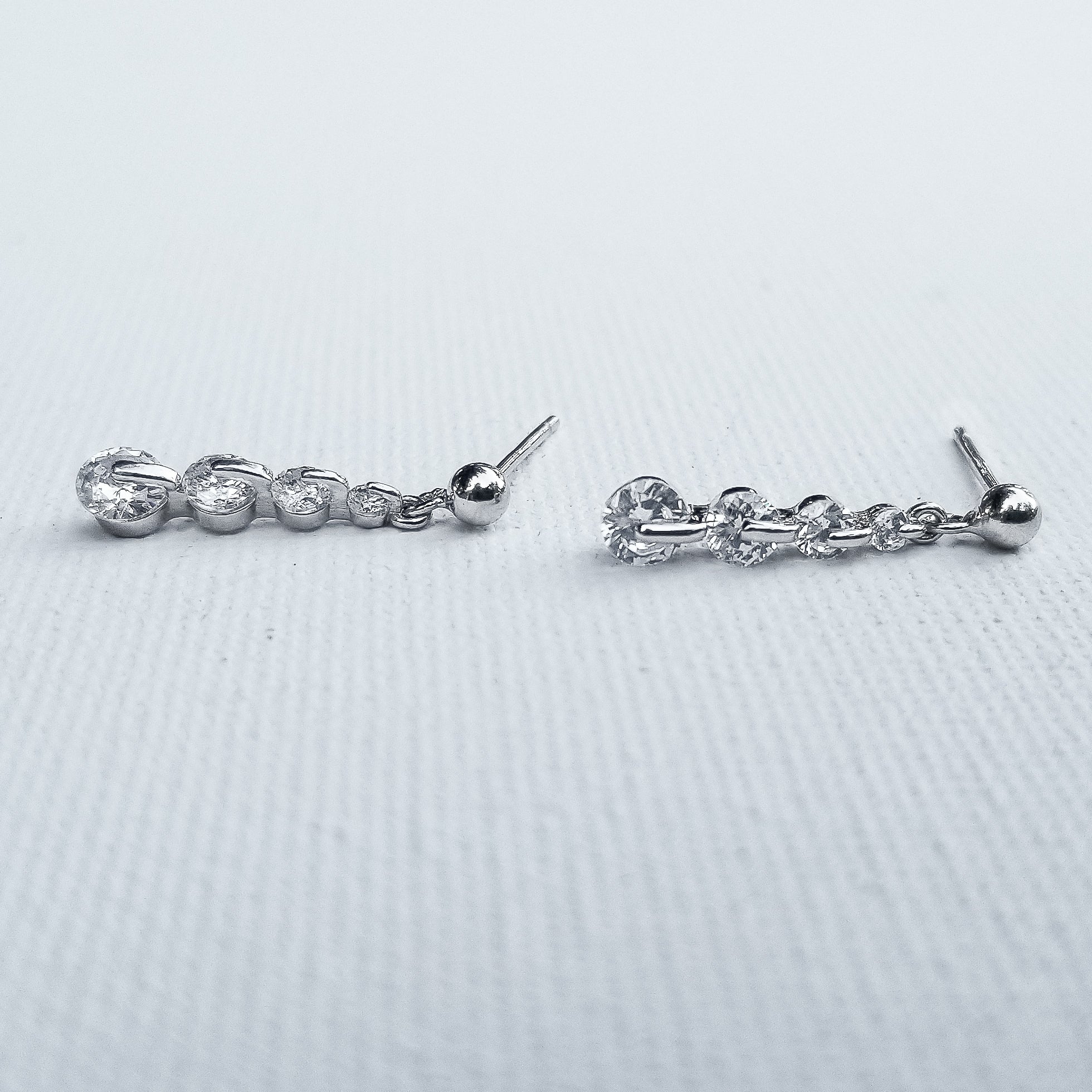 Sparkle your way to the top with the gorgeous Linear Drop Cubic Zirconia Earrings. The chain, crafted in 925 Sterling Silver and plated in White Gold showcasing 5 Cubic Zirconia is the perfect touch of glow  and elegance. Perfect for special occasions or everyday styling to show your amazing confidence and glam.
