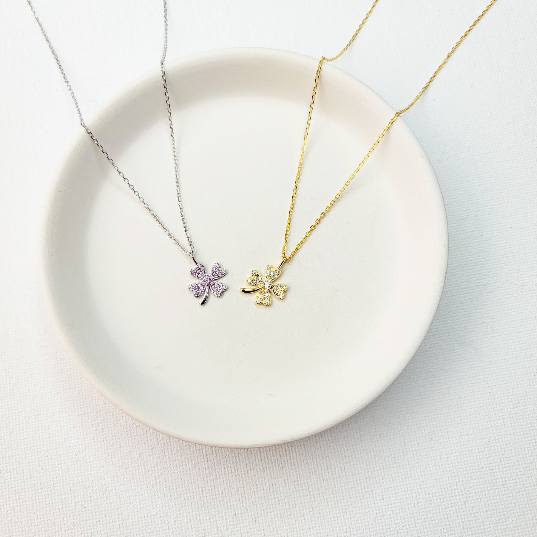 A beautiful design featuring a graceful four-leaf clover handcrafted in Sterling Silver and plated in 14 K Gold, the Lucky Clover and Sparkles Necklace showcases tiny cubic zirconia stones ( pink or white). Recognized as the universal symbol of good luck, this clover pendant necklace can be a wonderful gift for any occasion. Options:      Sterling Silver with14 K White Gold Plating and Pink Zirconia Stones Sterling Silver with 14 K Yellow Gold Plating and White Zirconia Stones