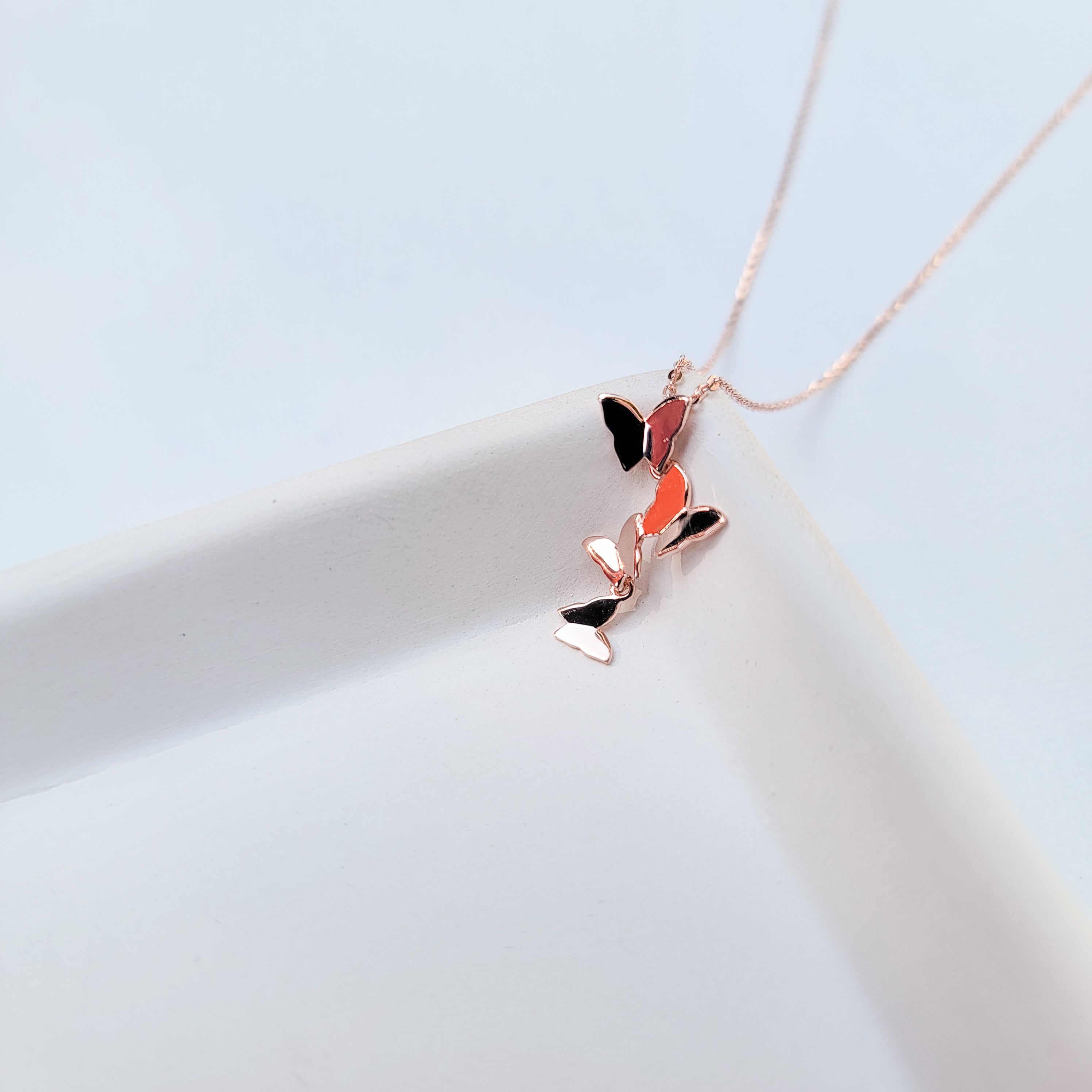 Add elegance and grace to your looks with this charming symbol of new life, letting go of old cycles and finding your true inner expression. Crafted in 925 Sterling Silver and dipped in Rose Gold, this delicate necklace features a group of four graceful butterflies. It’s the perfect gift to yourself or somebody special.  Material: Rose Gold plating over 925 Sterling Silver base Necklace length: 16 inch Pendant Shape: four-leaf clover Nickel & Lead-free & Hypoallergenic