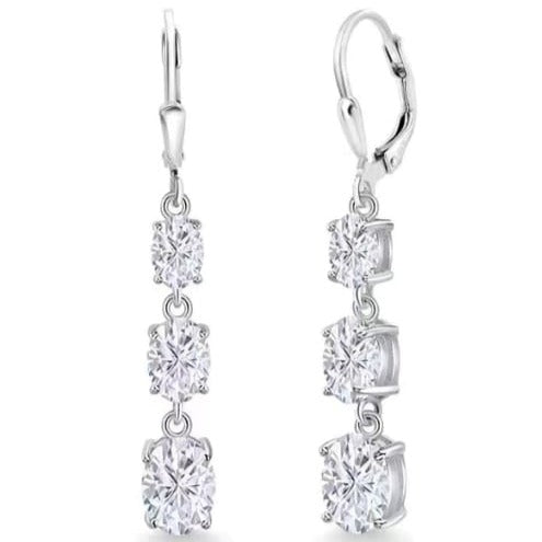 The Astrid Earrings feature 1.2 Carat Moissanite diamonds for each earring, boasting extraordinary beauty. They are crafted in Certified Sterling Silver and plated in 18K White Gold each earring featuring three brilliant Moissanite stones. Exuding sophistication, they are perfect for special occasions and make a great option as Bridal earrings.  Lever backs provide security and comfort all day long.