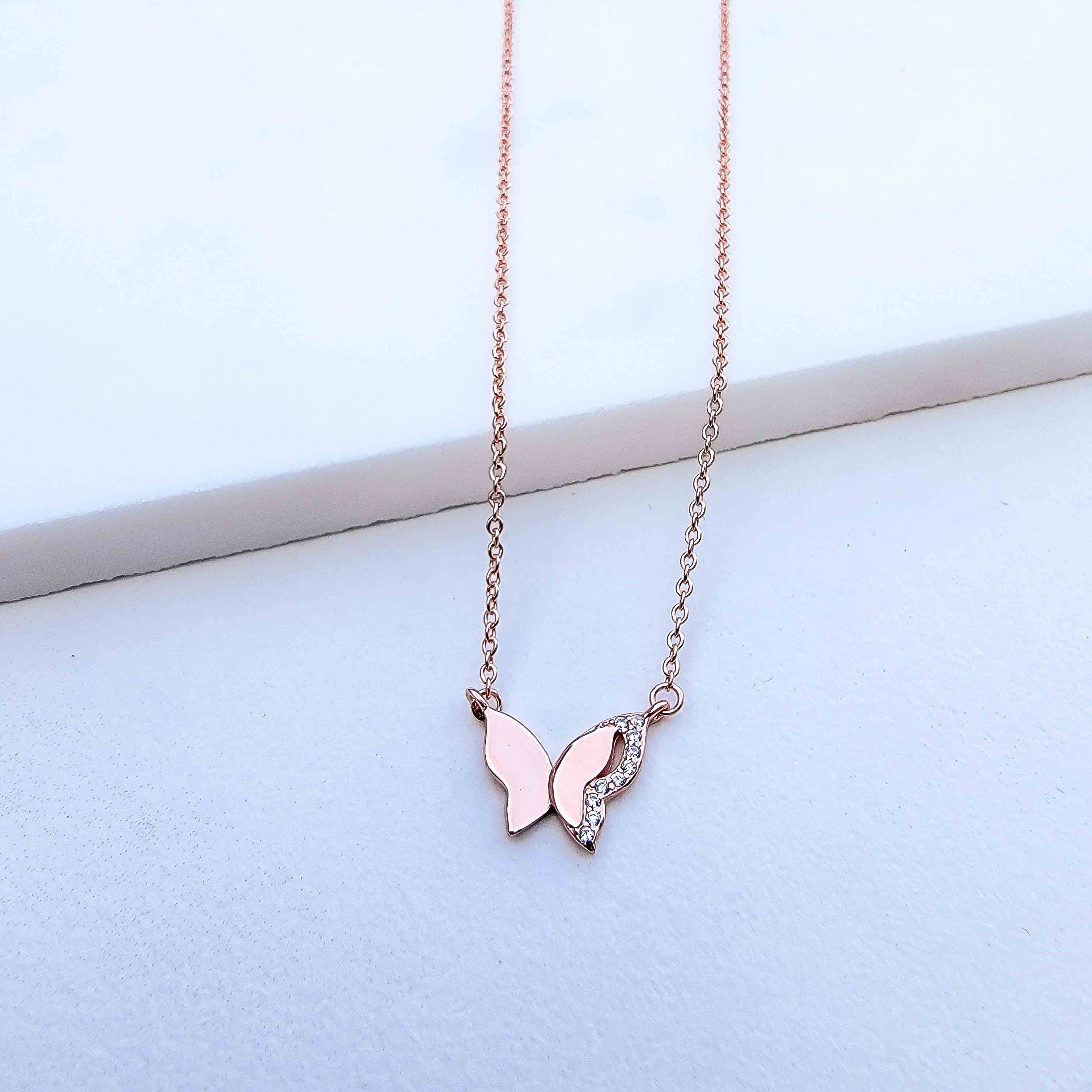  As the universal symbol of transformation and evolution, the butterfly also represents femininity and sensuality. Delicate, elegant and charming, the Sparkle Wing Butterfly Necklace features a butterfly pendant crafted in Sterling Silver, plated in Rose Gold and decorated with cubic zirconia stones.   Metal: 925 Sterling Silver with 18K Rose Gold plating Chain Length:16 Inches Nickel & Lead free & Hypoallergenic Complimentary Gift Box Included
