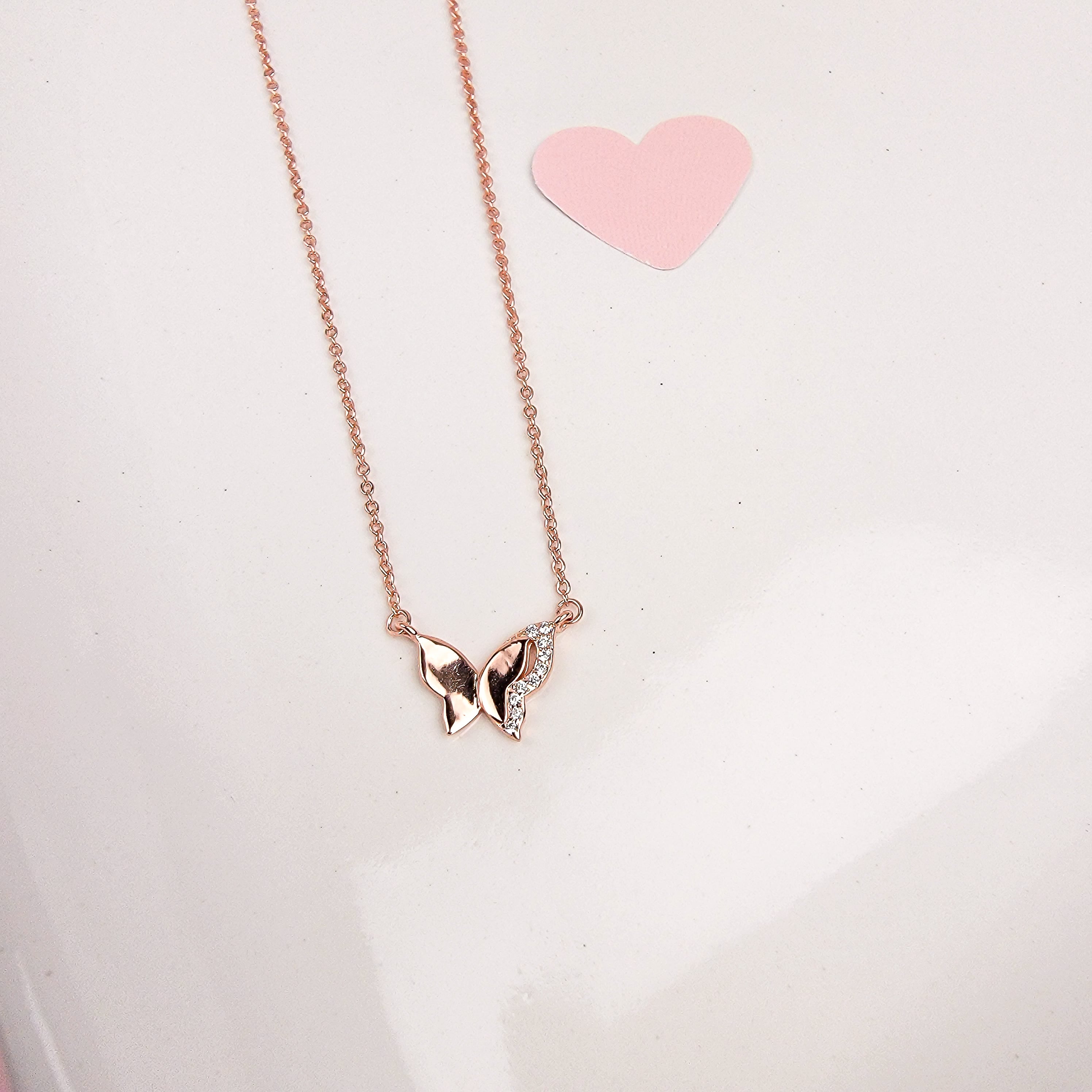  As the universal symbol of transformation and evolution, the butterfly also represents femininity and sensuality. Delicate, elegant and charming, the Sparkle Wing Butterfly Necklace features a butterfly pendant crafted in Sterling Silver, plated in Rose Gold and decorated with cubic zirconia stones.   Metal: 925 Sterling Silver with 18K Rose Gold plating Chain Length:16 Inches Nickel & Lead free & Hypoallergenic Complimentary Gift Box Included