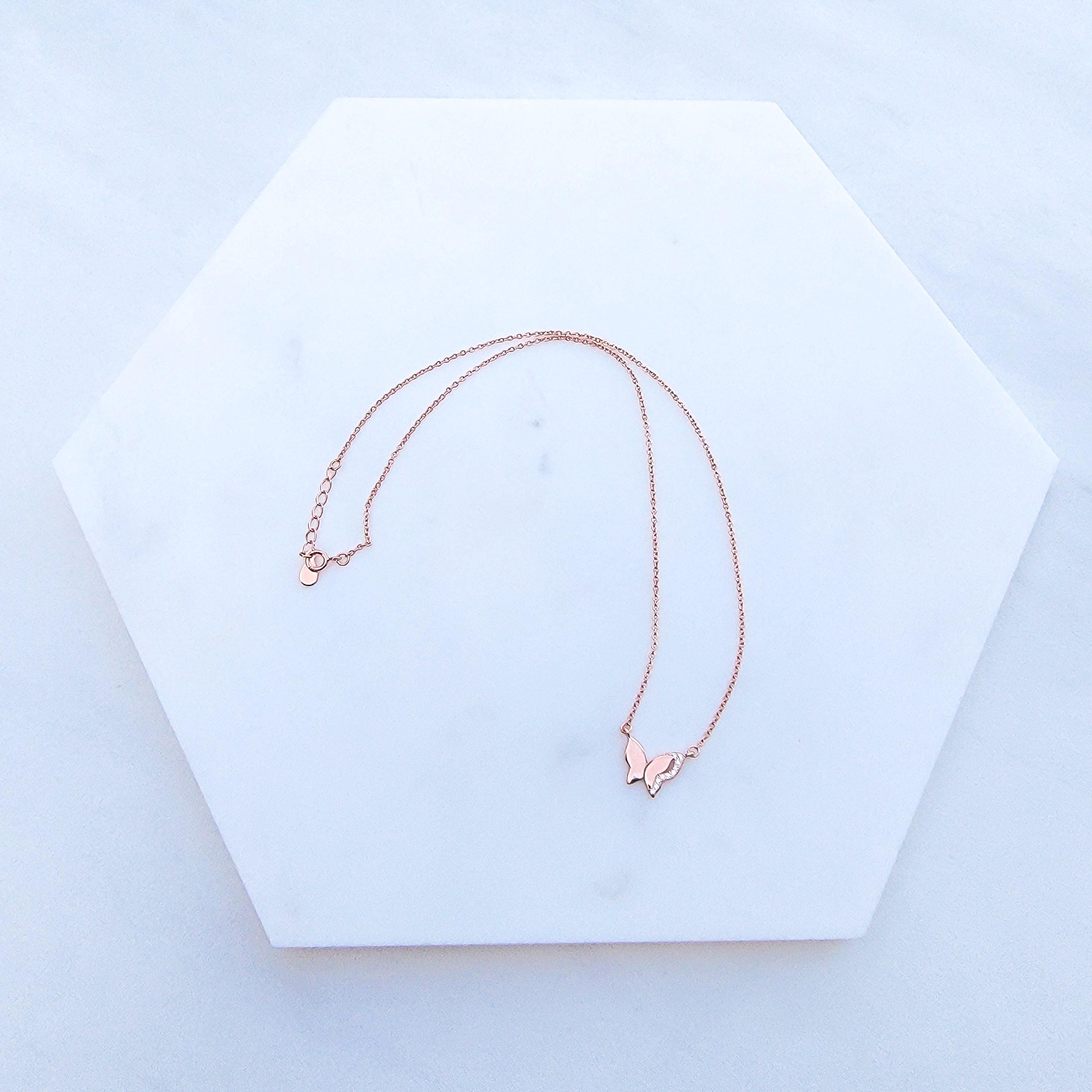  As the universal symbol of transformation and evolution, the butterfly also represents femininity and sensuality. Delicate, elegant and charming, the Sparkle Wing Butterfly Necklace features a butterfly pendant crafted in Sterling Silver, plated in Rose Gold and decorated with cubic zirconia stones.   Metal: 925 Sterling Silver with 18K Rose Gold plating Chain Length:16 Inches Nickel & Lead free & Hypoallergenic Complimentary Gift Box Included