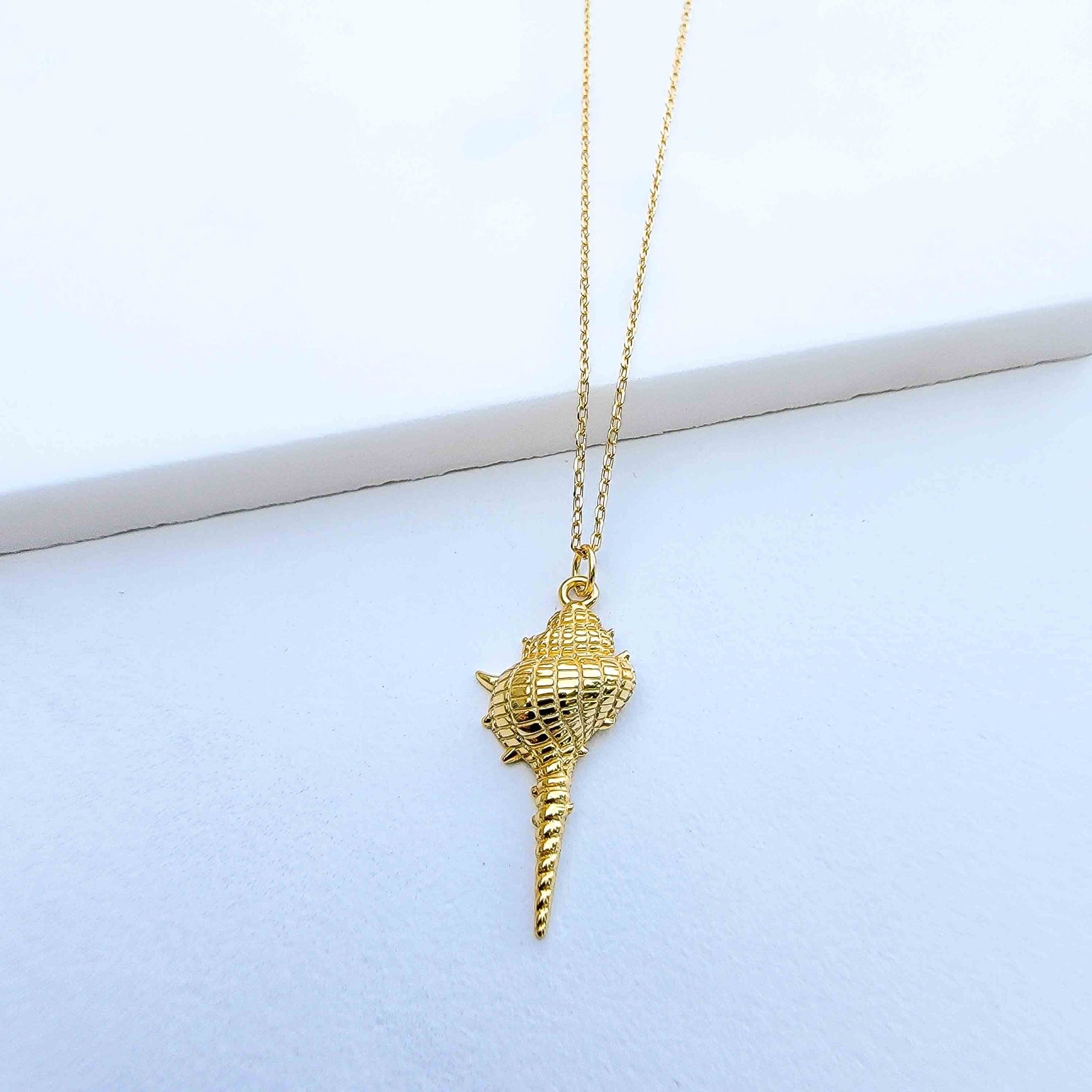 Are you dreaming of the beach? What a stylish way to add some under the sea glamour to your life with this Dazzling Conch Shell Necklace. Featuring a high polished finish for long-lasting shine, the conch shell pendant hangs from a 17-inch chain. Both the pendant and chain are crafted in 925 Sterling Silver and are plated in Gold. Do you prefer white Gold or yellow Gold?  