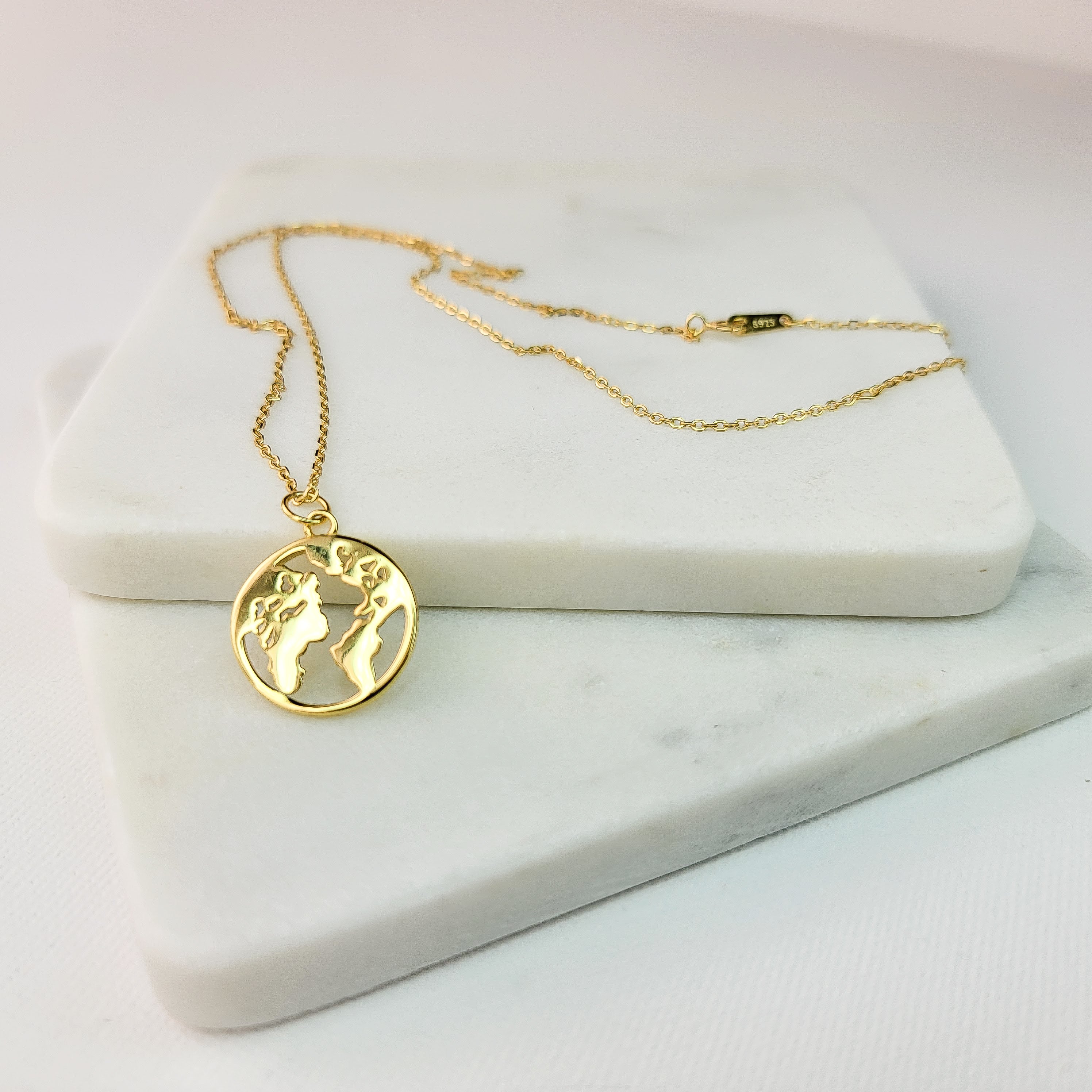 This world map necklace is your dynamic jewelry piece that will be signature to your look. It is elegant, yet casual for everyday wear. This necklace is the simplistic symbol of the traveler at heart and an invitation for conversation. Metal: 925 Sterling Silver with 18 K Gold plating Length :15.5 inches + 2 inches Nickel & Lead-free & Hypoallergenic