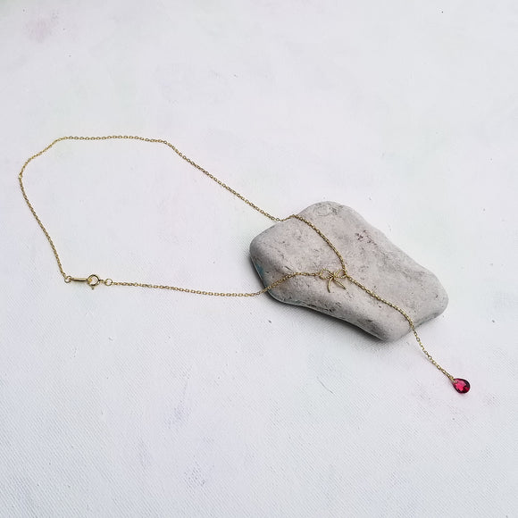 This beautiful choker - lariat style necklace features an elegant bow and a tear cut red zirconia stone. The details really stand out on this necklace. The slender chain and delicate profile make it the ideal everyday piece and it can also be a centerpiece for a special occasion. Material:  14K Gold Plated over 925 Sterling Silver Stone: Red Cubic Zirconia Style: Choker Style Necklace - Bowknot, Tassel Chain Length: 16 Inch Nickel & Lead free & Hypoallergenic