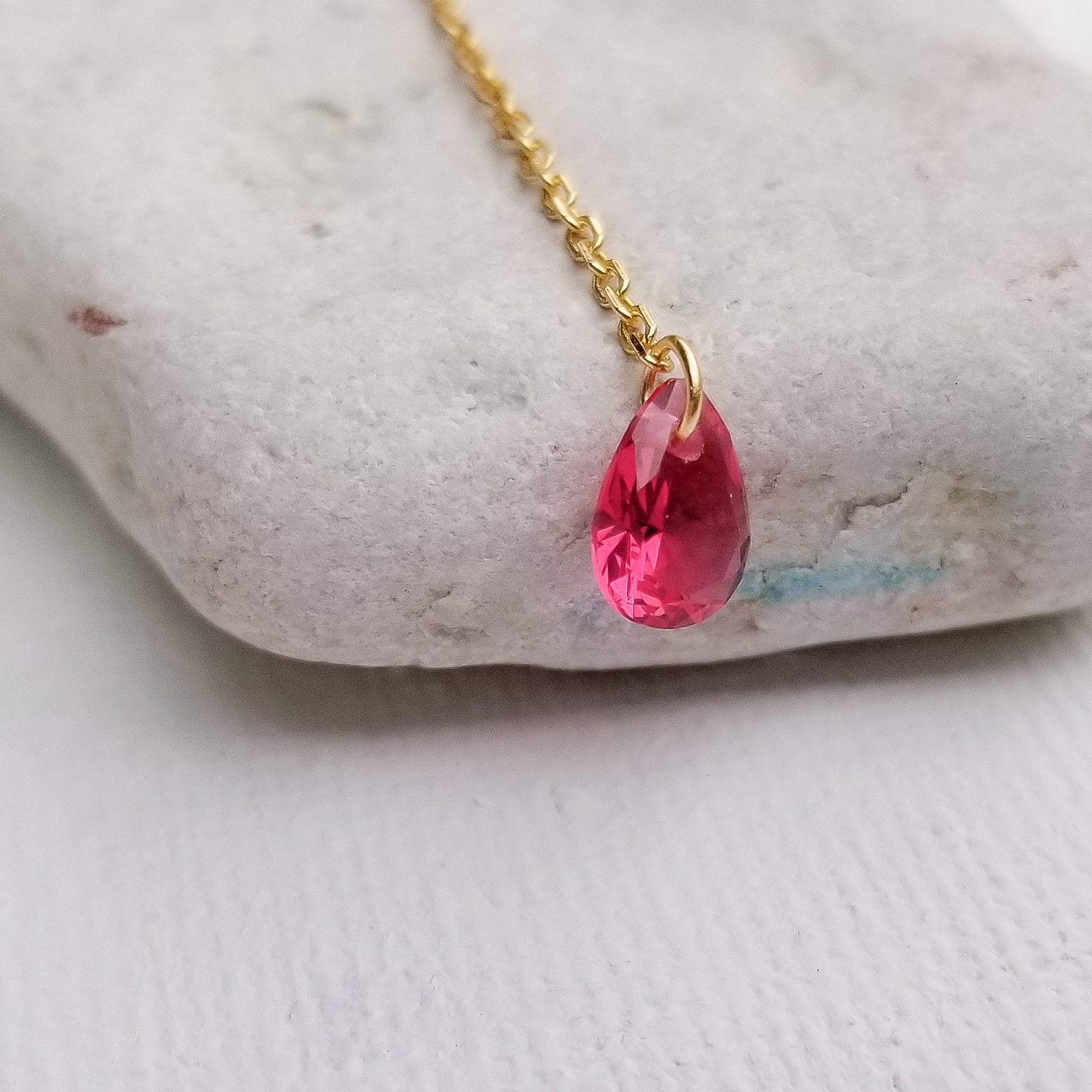 This beautiful choker - lariat style necklace features an elegant bow and a tear cut red zirconia stone. The details really stand out on this necklace. The slender chain and delicate profile make it the ideal everyday piece and it can also be a centerpiece for a special occasion. Material:  14K Gold Plated over 925 Sterling Silver Stone: Red Cubic Zirconia Style: Choker Style Necklace - Bowknot, Tassel Chain Length: 16 Inch Nickel & Lead free & Hypoallergenic