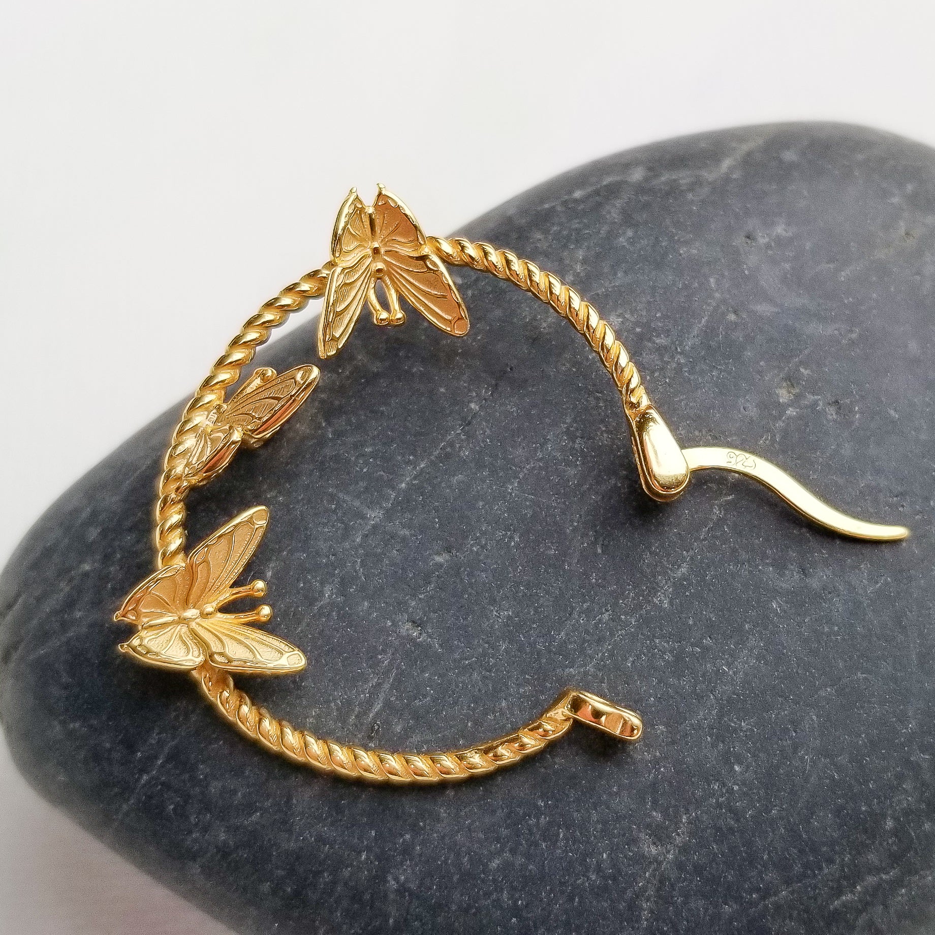 Who does not like butterflies? One of nature's most beautiful creatures is captured perfectly via this delicate pair of butterfly earrings. Crafted beautifully in a flying position, in 14K Gold Plated 925 Sterling Silver, the Flying Butterflies Earrings dangle below the earlobes for a subtle and beautiful look.  Material: 14K Gold Plated 925 Sterling Silver Shape: Butterflies on a hoop style Nickel & Lead free & Hypoallergenic Earrings are held in place by Sterling Silver earring backs.